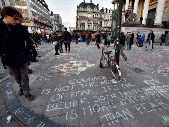 brussells people write hundreds of messages on the asphalt at place de la bourse in the center of brussels to mourn for the victims of bomb attack